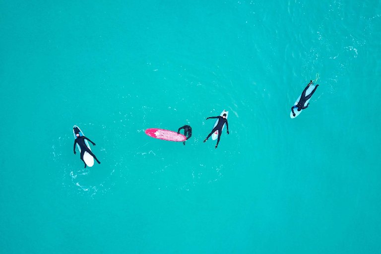 Surfers relaxing on their surfboards.